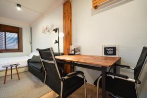 a room with a desk and chairs and a bed at Dec Room at Shine Haus BangSue in Bang Su +24 photos