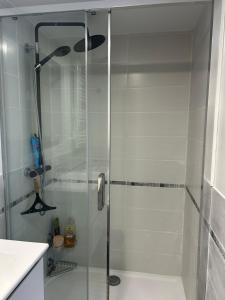 a shower with a glass door in a bathroom at chez Riva et Christophe in Luynes