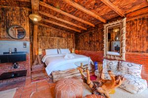 a bedroom with a bed in a wooden room at La Cabane Marocaine in Essaouira