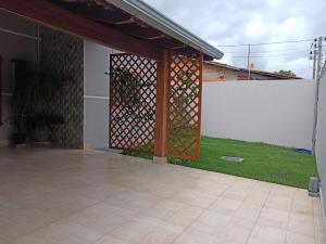 a screened in entry to a house with a fence at Aconchego, lazer IC in Pirenópolis