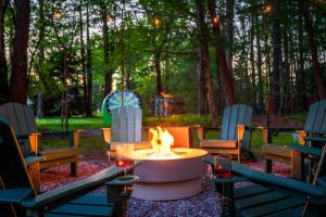 a fire pit in the middle of a yard with chairs at Theater*2 Game Rooms *Sauna *Hot Tub*Fall Specials in Blakeslee