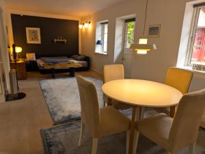 a living room with a table and chairs and a couch at Birkevang holiday apartment in idyllic countryside in Faxe