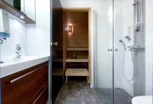 a bathroom with a shower and a sink and a toilet at Raito Apartment in Saariselka