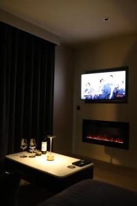 a room with a table with wine glasses and a tv at House 15 in Kenmare +33 photos
