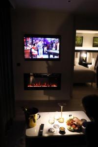 a living room with a tv and a fireplace at House 15 in Kenmare