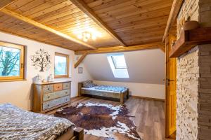 a bedroom with a bed and a bench in a room at Chalet Malá Strana in Lučany nad Nisou