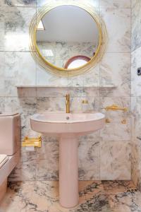 a bathroom with a sink and a mirror at Los Penones Experiences A - Solo Adultos in El Sao