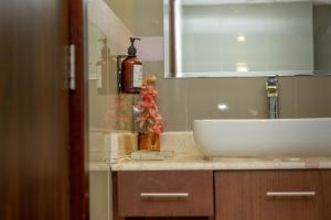 a bathroom with a white sink and a mirror at Sohar Beach Hotel in Sohar +24 photos