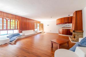 a living room with wood paneling and a fireplace at Los Penones Experiences A - Solo Adultos in El Sao