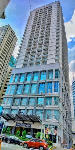 a large building with cars parked in front of it at Seri Suites KLcc in Kuala Lumpur
