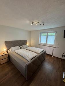 a bedroom with a large bed and a window at Haus Jäger in Lermoos
