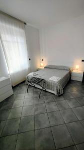 a bedroom with two beds and two windows at casa Camillo in Novara