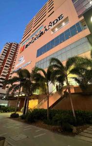 a building with palm trees in front of it at Cartagena Colombia- h2 Hyatt condo-Bay view in Cartagena de Indias