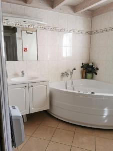a white bathroom with a tub and a sink at Ferienhaus Baabe in Baabe +18 photos