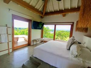 a bedroom with a large bed and a large window at Rancho Eden in Armenia +58 photos