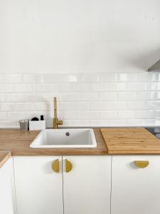 a kitchen with a sink and white cabinets at Lúmina Vir in Vir +12 photos