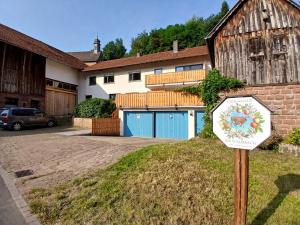 a sign in a yard in front of a house at Ferienwohnung "Wasser" mit Sauna im Ferienhaus am Waldbach in Kirchzell