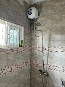 a shower with a shower head in a bathroom at Private Villa in Bagamoyo in Bagamoyo