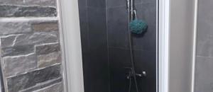 a glass shower door with a blue sponge in it at Novi Pazar Nest Inn in Novi Pazar +6 photos