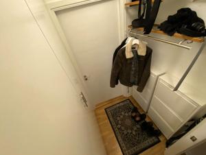 a small room with a door and a rug at City apartment with balcony in Norrköping +1 photo