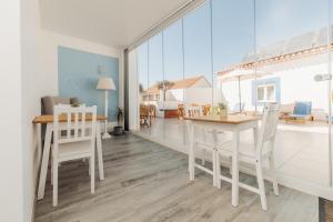 a living room with a white table and chairs at AZUL in Zambujeira do Mar