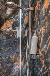 a shower with a blow dryer on a wall at Contractors! Free parking, Wifi, 6 BDR, 10 Beds! in Elswick