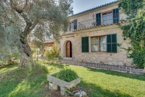 a stone house with a tree in front of it at Finca Moscari in Madrid