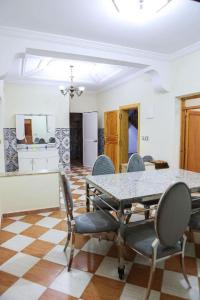 a dining room with a table and chairs at najmatrif in Driouch