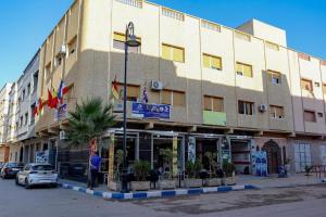 a large building with people standing outside of it at najmatriff in Driouch