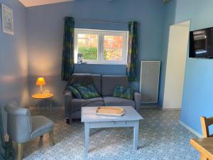 a living room with a couch and a table at Les Gîtes de Leymandie in Saint-Avit-de-Vialard
