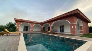 a villa with a swimming pool and a house at L'Eclipse Air-Conditioned Villa with Pool in Mbour