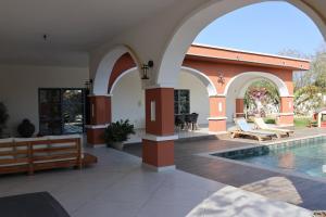 a house with a swimming pool and an archway at L'Eclipse Air-Conditioned Villa with Pool in Mbour