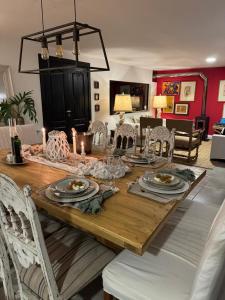 a dining room table with plates and wine glasses at Casa Carite in Ocean Park