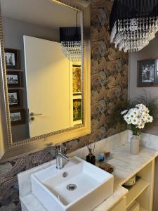 a bathroom with a sink and a mirror at Casa Carite in Ocean Park