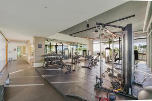 a gym with several treadmills and cardio machines at Sea View with Private Beach Access! 3BR & Maid Rm in Dubai