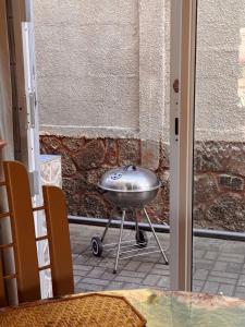 a silver grill sitting in front of a door at Montagu Villas 3min Beach Walk in Flic-en-Flac
