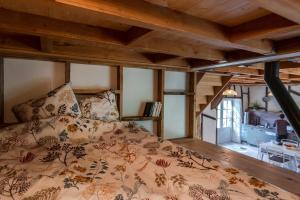 a bed in a room with wooden ceilings at L'arbres aux minutes in Saint-Martin-Sepert