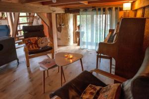 a living room with a piano and a couch at L'arbres aux minutes in Saint-Martin-Sepert