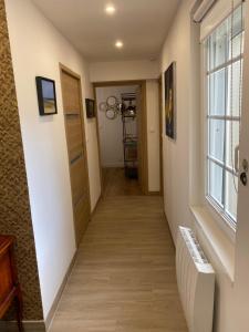 a hallway with a door and a window at Villa Les Sables in Condette +10 photos