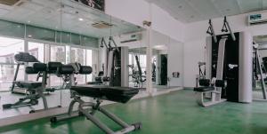 a gym with treadmills and ellipticals in a room at Alraya Homes by Betu former Times Inn in Abu Dhabi