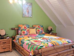 a bedroom with a bed with a colorful comforter at Villa Caillou in Lamentin +45 photos