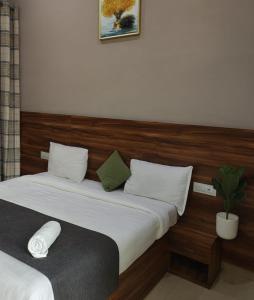 a bedroom with two beds and a potted plant at The Silverkey Hospitalilty - Krishiv palace Hotel in Vrindāvan