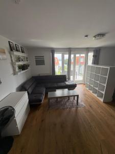 a living room with a couch and a coffee table at Inselblick am Wasser in Werder