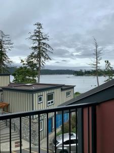 a house with a car parked on a balcony at Sooke Harbour Hideaway - Luxurious Vacation Rental in Sooke