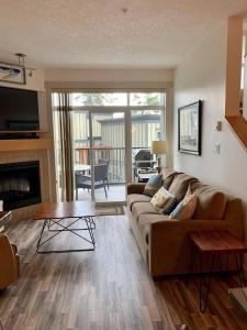 a living room with a couch and a table at Sooke Harbour Hideaway - Luxurious Vacation Rental in Sooke