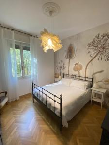 een slaapkamer met een bed en een kroonluchter bij Malmusi Apartment in Modena