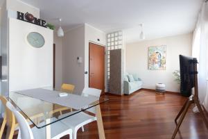 a dining room and living room with a table and chairs at Principe di Piemonte Apartment in Campobasso