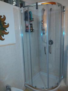 a shower with a glass door in a bathroom at CASA MIKY in Palermo