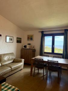 a living room with a couch and a table at Panoramicissima in Costa Rei