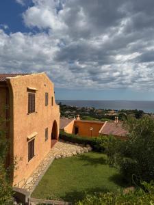 an external view of a building with the ocean in the background at Panoramicissima in Costa Rei
